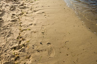 High angle view of footprints on beach