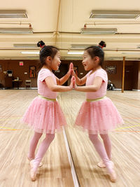 Young lady dancing in front of mirror