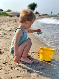 Side view of boy playing at beach