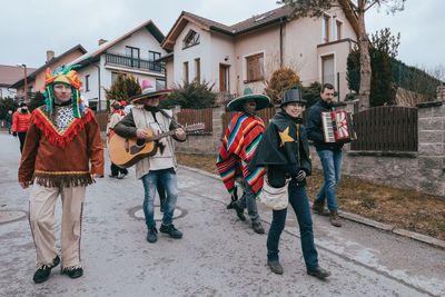 People standing outside house