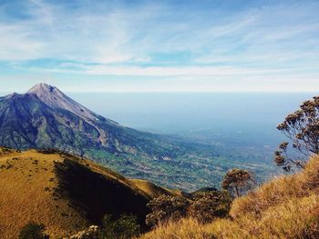 Scenic view of mountains against cloudy sky