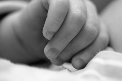 Close-up of hand holding baby