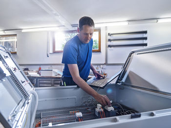 Man working on escalator