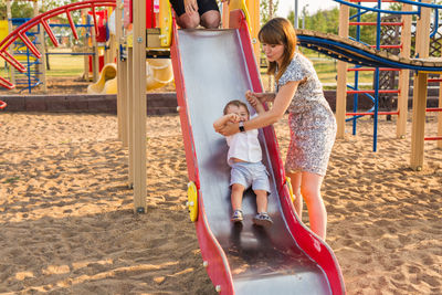 Girl playing on slide at playground