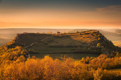 Scenic view of field against sky during sunset