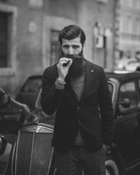 Young man standing in car