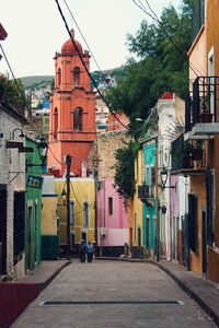 Empty street along buildings