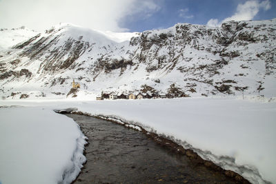 Scenic view of snow covered mountains against sky