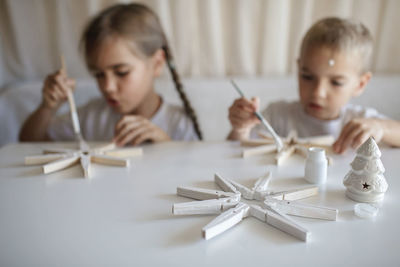Cute kids making christmas decoration at home