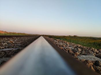 Surface level of railroad track against sky