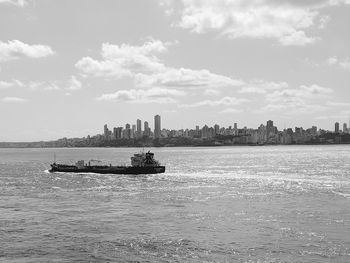 Scenic view of sea and buildings against sky