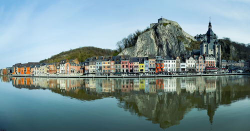 Reflection of buildings in lake against sky