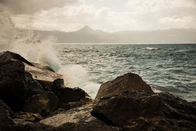 Waves splashing on rocks at beach