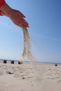 Man on beach against clear sky