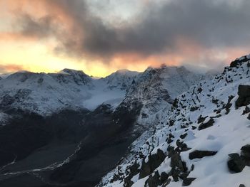 Scenic view of snowcapped mountains against sky during sunset