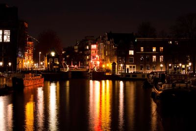 Reflection of illuminated buildings in water at night