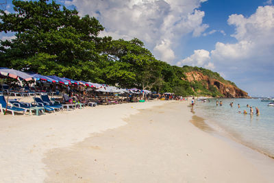 Group of people on beach against sky