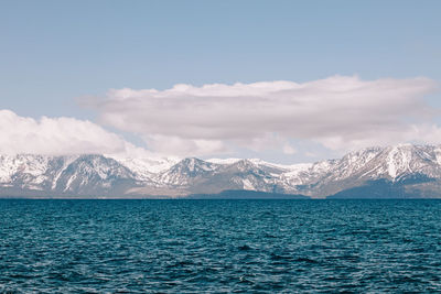 Blue water and snowy mountains on the background, lake tahoe landscape