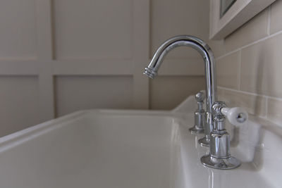 Close-up of faucet in bathroom at home