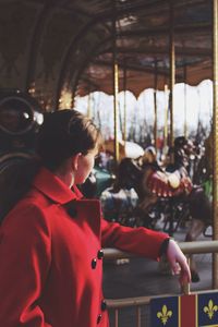 Woman standing at carousel