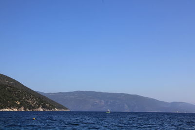 Scenic view of mountains against blue sky