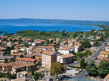 High angle view of townscape by sea against sky