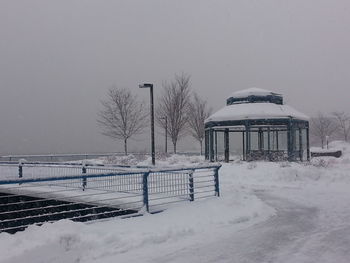 Built structure on snow covered field against sky