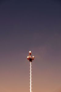 Low angle view of person paragliding against sky