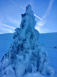 Snow covered mountain against blue sky