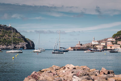 Sailboats sailing in sea against sky