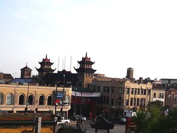 Buildings in city against clear sky