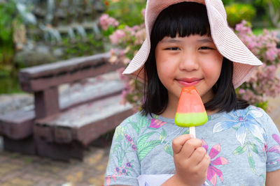 Portrait of smiling girl eating ice cream
