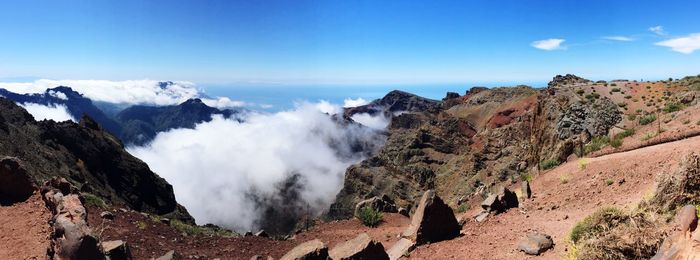 Panoramic view of mountains against blue sky