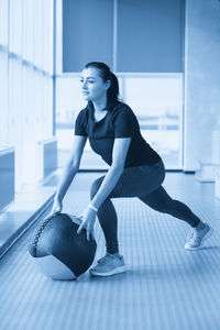 Young woman exercising in gym