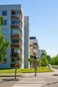 Residential building by street against sky