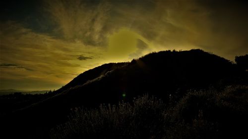 Scenic view of silhouette mountains against sky at sunset