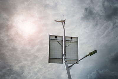 Low angle view of street light against cloudy sky