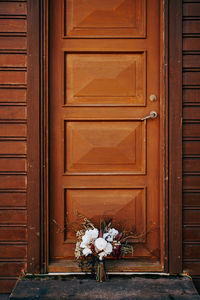 Flower pot against closed door of building