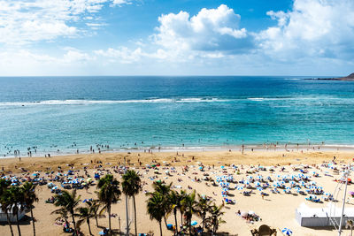 High angle view of people on beach against sky