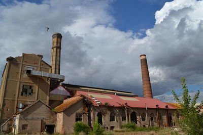 Low angle view of building against cloudy sky