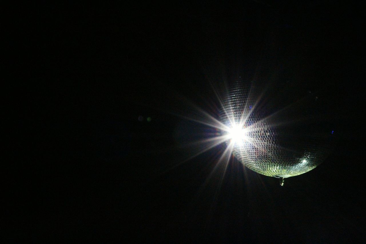 LOW ANGLE VIEW OF ILLUMINATED LIGHTING EQUIPMENT IN BLACK BACKGROUND