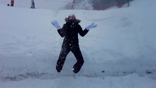 Full length of person on snow covered field