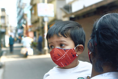 Close-up portrait of boy in city