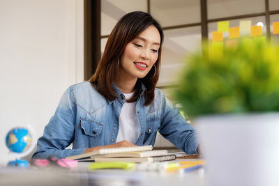 Young businesswoman working at desk in office