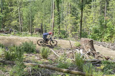 Man riding bicycle in forest