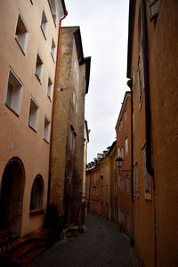 Narrow alley amidst buildings in town