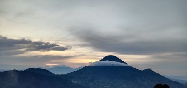 Scenic view of snowcapped mountains against sky during sunset