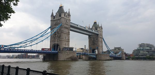 View of bridge over river against cloudy sky