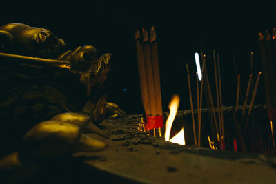 Close-up of lit candles in temple