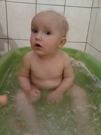 Close-up of baby girl sitting in bathroom